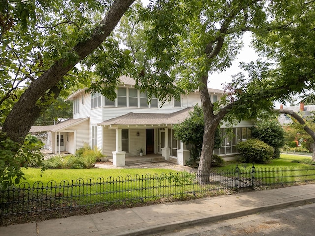 view of front of home featuring covered porch and a front lawn