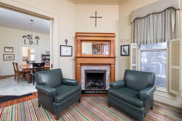 living room featuring an inviting chandelier, hardwood / wood-style flooring, and crown molding