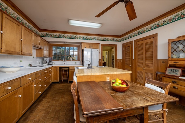 kitchen with crown molding, white appliances, ceiling fan, sink, and tasteful backsplash