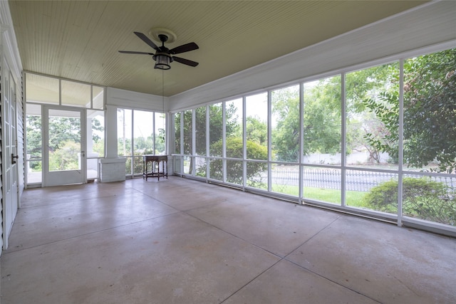 unfurnished sunroom with ceiling fan and a wealth of natural light