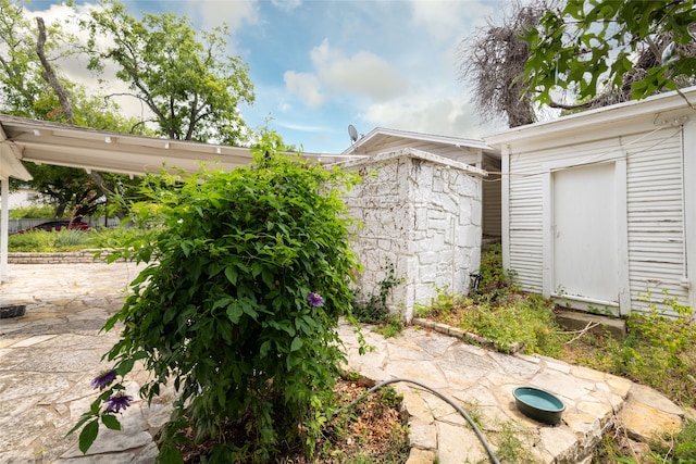 view of patio / terrace with an outbuilding