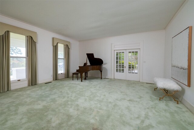 unfurnished room with crown molding, french doors, and carpet floors