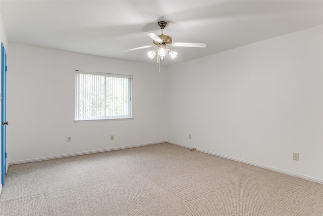 spare room featuring carpet floors and ceiling fan