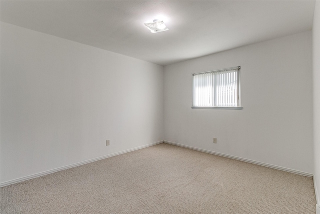 unfurnished room featuring light colored carpet