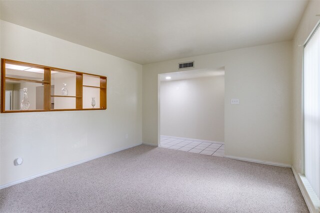 unfurnished room with light carpet