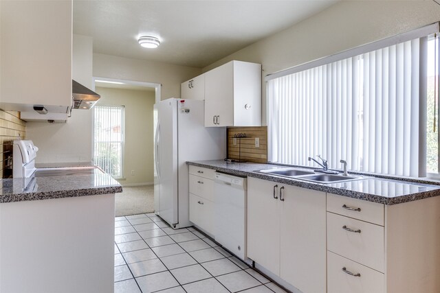 kitchen with light tile patterned flooring, wall chimney exhaust hood, decorative backsplash, and white appliances