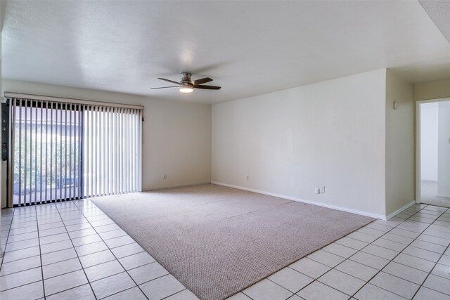 spare room with light tile patterned flooring and ceiling fan