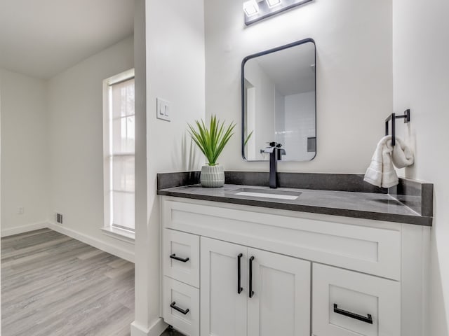 bathroom with vanity and hardwood / wood-style floors