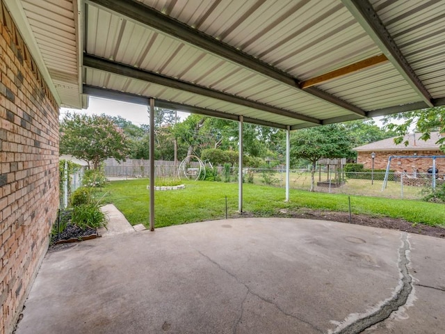 view of patio / terrace featuring a carport and a fenced backyard