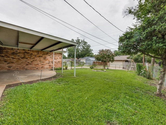 view of yard with fence and a patio