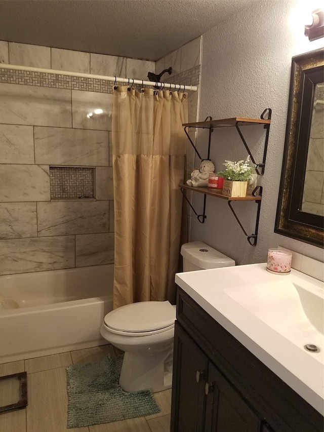 full bathroom featuring vanity, toilet, a textured ceiling, and shower / bath combo