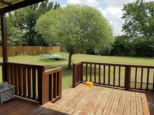 deck with a trampoline and a lawn