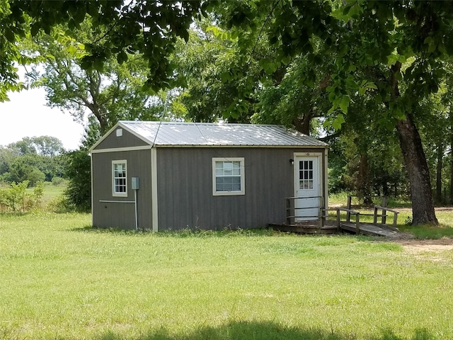 view of outbuilding with a yard