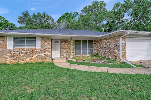 single story home with a front yard and a garage