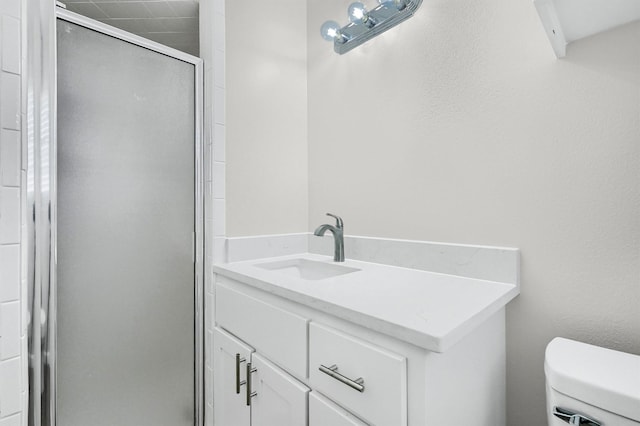 bathroom with vanity, an enclosed shower, and toilet