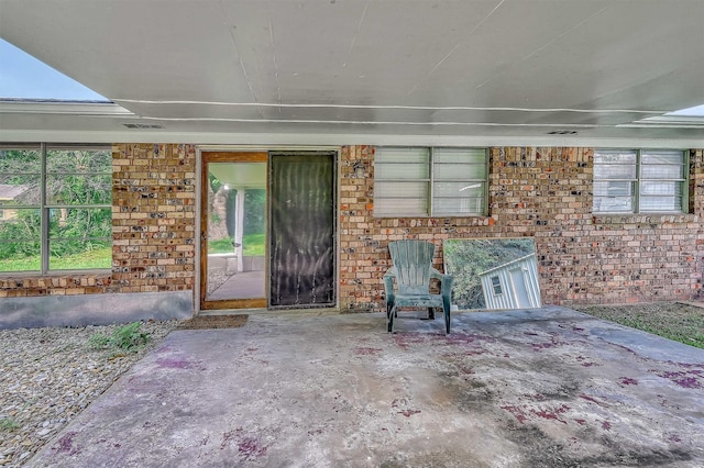 doorway to property with a patio area