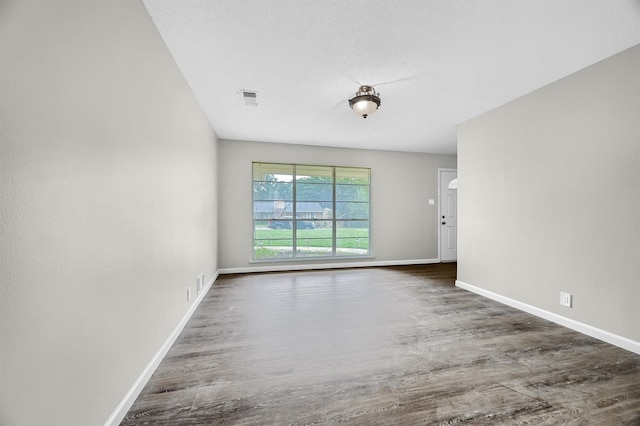 unfurnished room with dark hardwood / wood-style floors