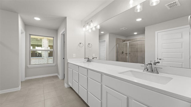 full bathroom featuring a shower stall, a sink, tile patterned flooring, and visible vents