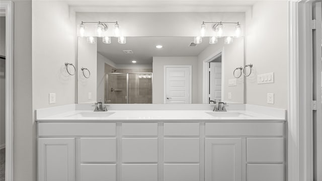 full bath featuring double vanity, visible vents, a sink, and a stall shower