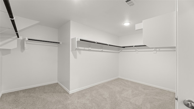 walk in closet featuring visible vents and carpet floors