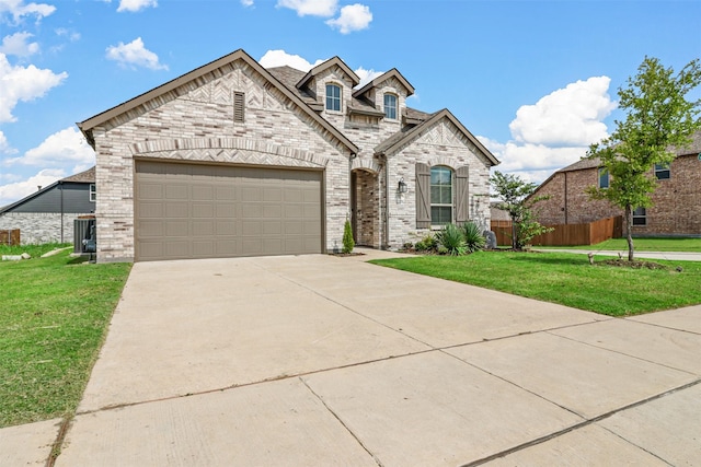 view of front of home with a garage and a front yard