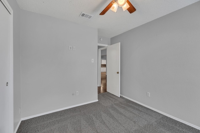 spare room featuring carpet flooring, a textured ceiling, and ceiling fan