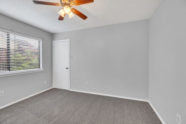 carpeted empty room featuring a textured ceiling and ceiling fan