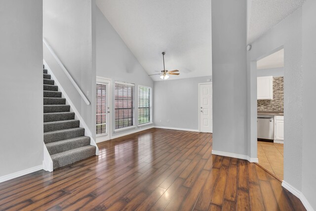 unfurnished living room featuring hardwood / wood-style flooring, high vaulted ceiling, and ceiling fan