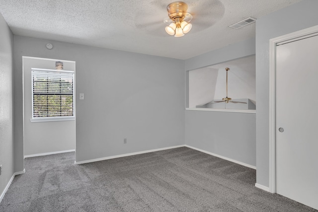 unfurnished room featuring carpet, ceiling fan, vaulted ceiling, and a textured ceiling