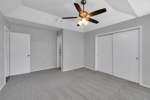 unfurnished bedroom with carpet, ceiling fan, and vaulted ceiling