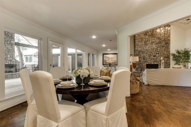 dining area with dark hardwood / wood-style floors, a fireplace, and a notable chandelier