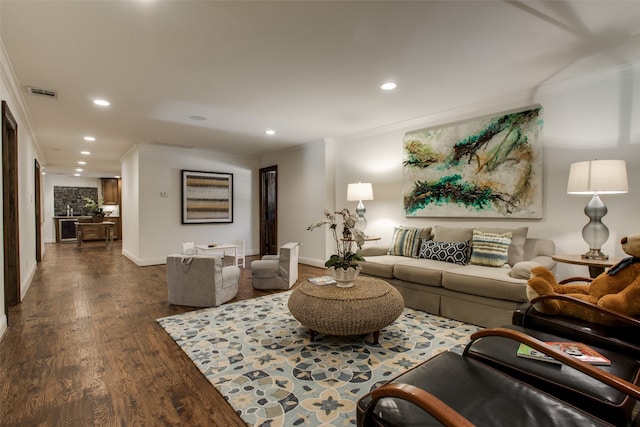 living room with dark wood-type flooring and ornamental molding