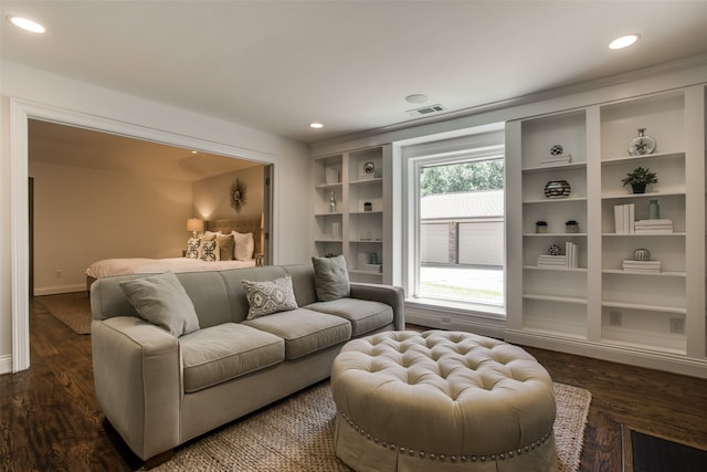 living room with dark wood-type flooring and built in shelves