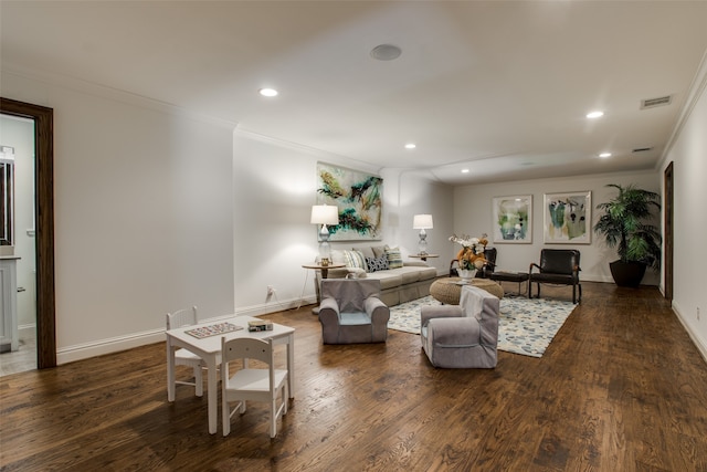 living room with dark wood-type flooring and crown molding