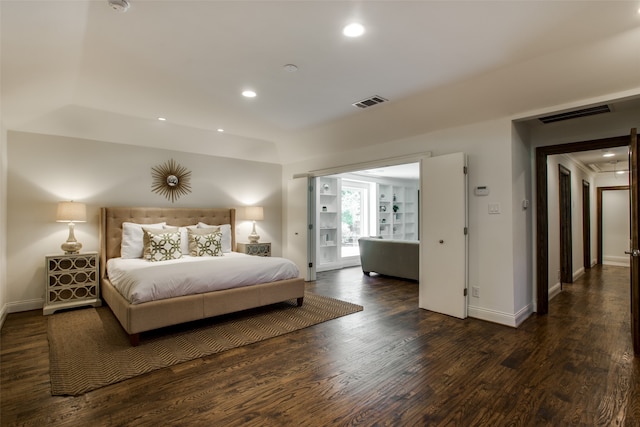 bedroom with dark hardwood / wood-style flooring and access to exterior