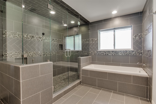 bathroom featuring independent shower and bath, tile walls, and tile patterned floors