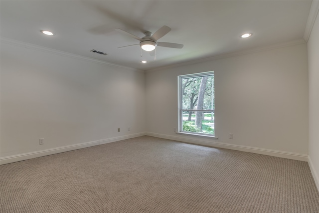 empty room featuring crown molding, ceiling fan, and carpet flooring