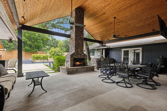 view of patio / terrace featuring an outdoor stone fireplace and ceiling fan