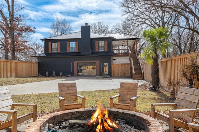 back of property with a fire pit