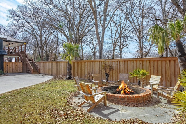 view of yard featuring a patio and an outdoor fire pit