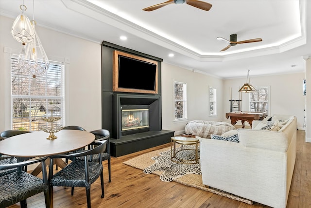 living room featuring ornamental molding, ceiling fan, and hardwood / wood-style floors