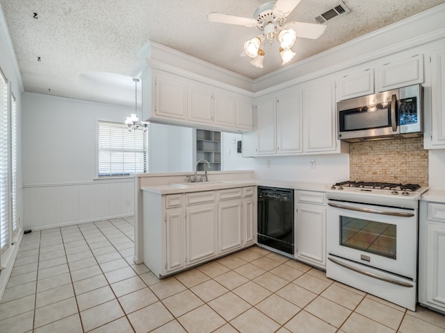 kitchen featuring crown molding, dishwasher, sink, white gas range, and kitchen peninsula