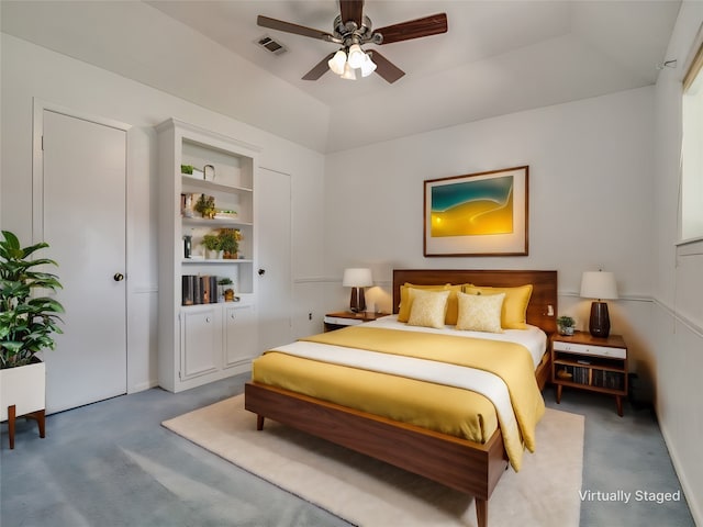 bedroom with carpet flooring, ceiling fan, and a raised ceiling