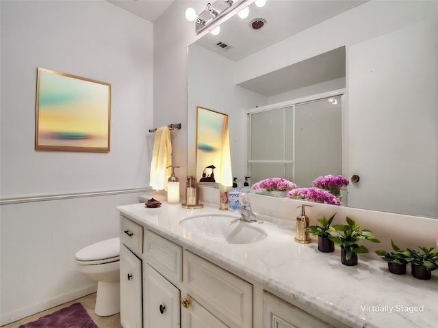 bathroom featuring vanity, toilet, and tile patterned flooring