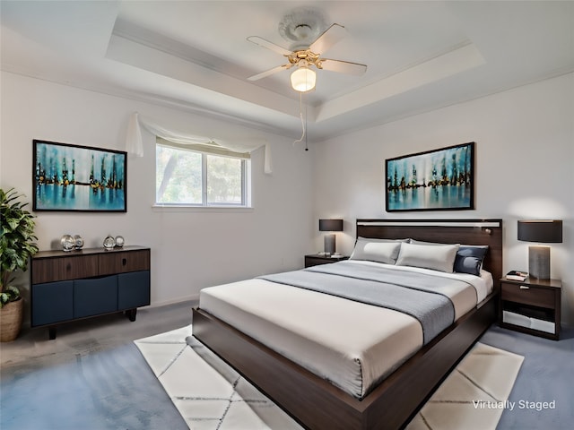 carpeted bedroom featuring ceiling fan, a raised ceiling, and crown molding