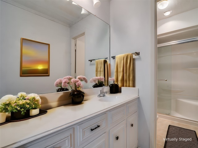 bathroom featuring tile patterned floors, vanity, and an enclosed shower