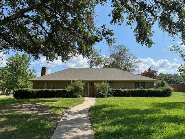 ranch-style home with a front lawn