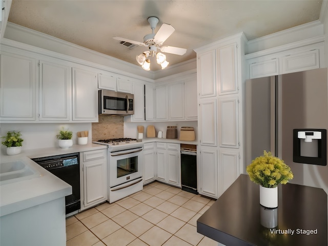 kitchen featuring white cabinets, stainless steel appliances, and crown molding