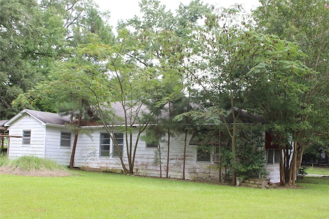 view of property exterior with a yard