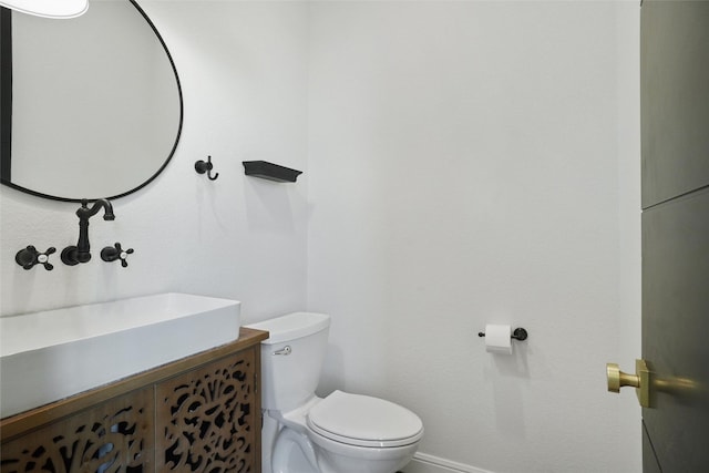 bathroom with toilet and vanity